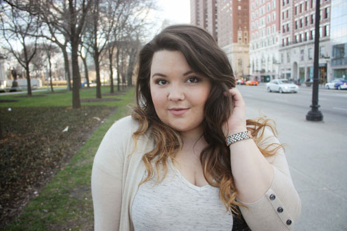 Curvy woman smiling outdoors