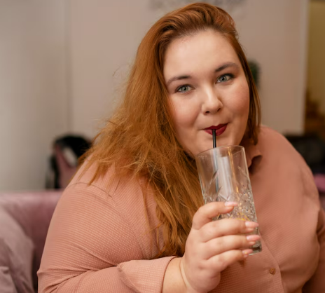 Plus-size woman smiling outdoors